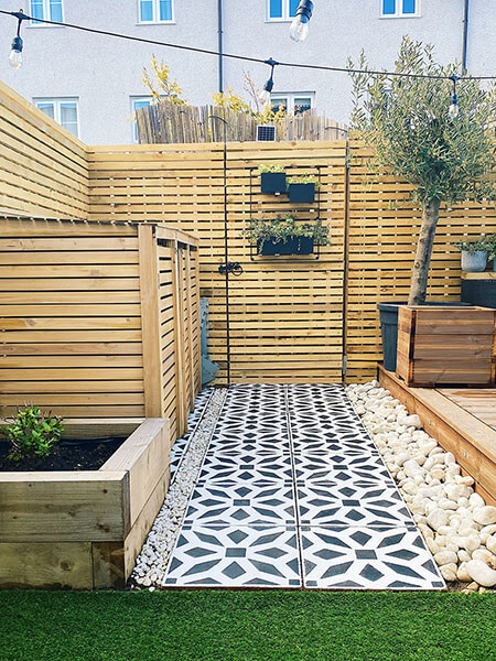 Patio tiles with a stensil design applied